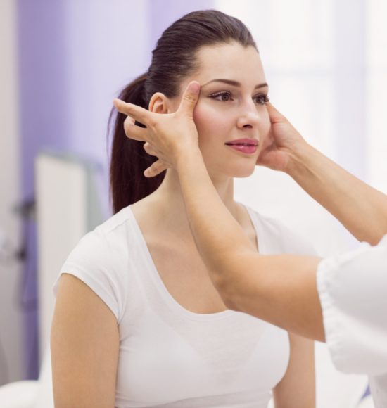 dermatologist-examining-female-patient-skin