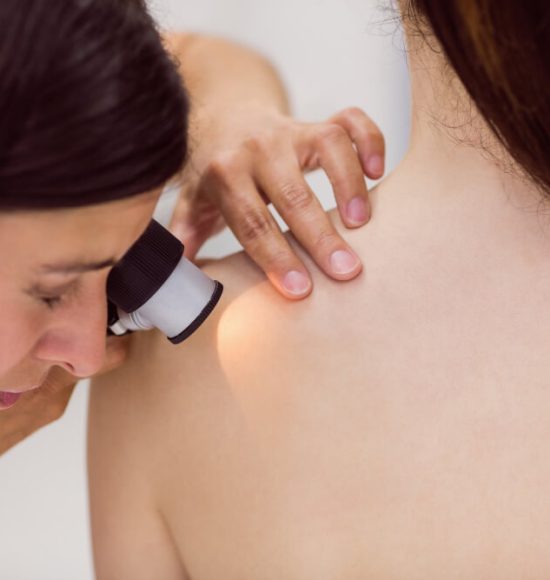 dermatologist-examining-skin-patient-with-dermatoscope (1)